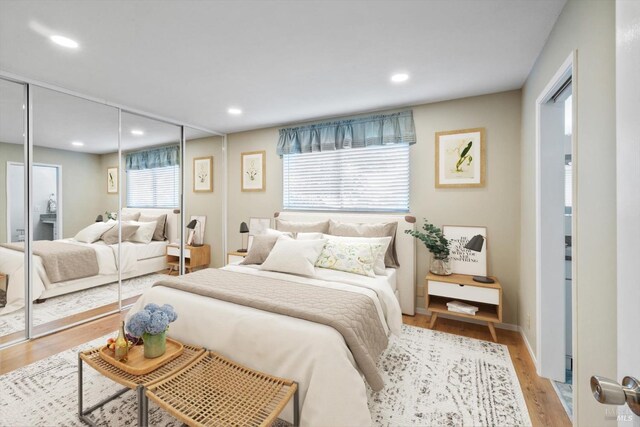 bedroom featuring light wood-style floors, a closet, and recessed lighting