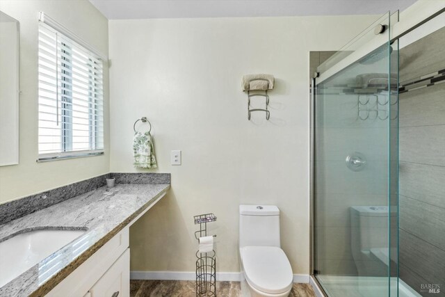 full bath with vanity, baseboards, toilet, and a shower stall