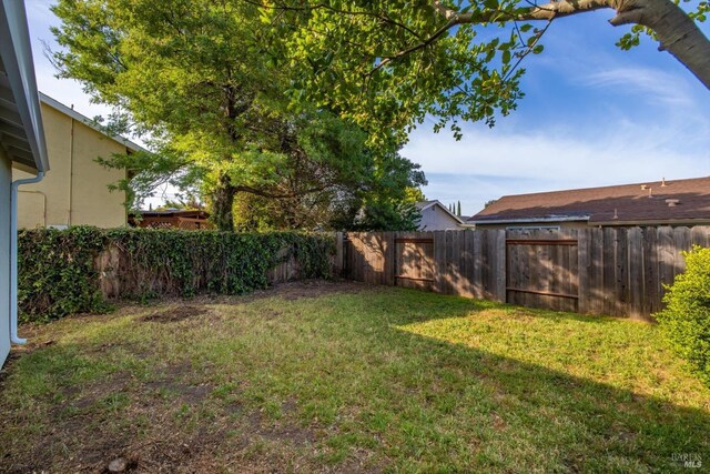 view of yard with a fenced backyard