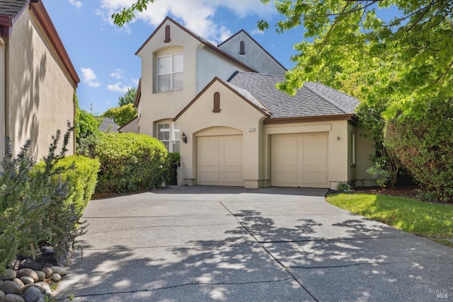 view of front of house featuring a garage, stucco siding, and concrete driveway