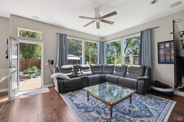 living room featuring recessed lighting, baseboards, a ceiling fan, and dark wood-style flooring