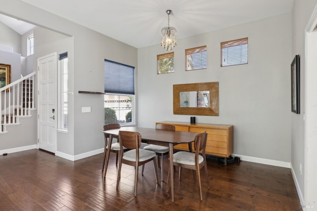 dining area featuring baseboards, stairs, a chandelier, and hardwood / wood-style flooring