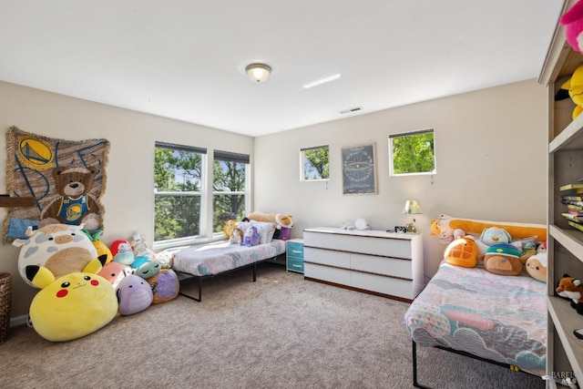 bedroom with visible vents, carpet flooring, and multiple windows