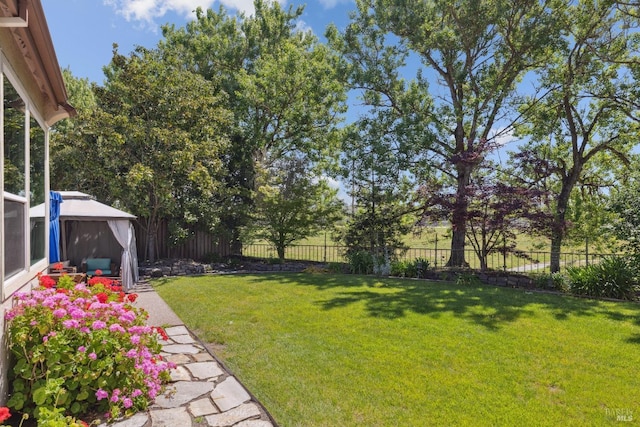 view of yard featuring a gazebo and a fenced backyard