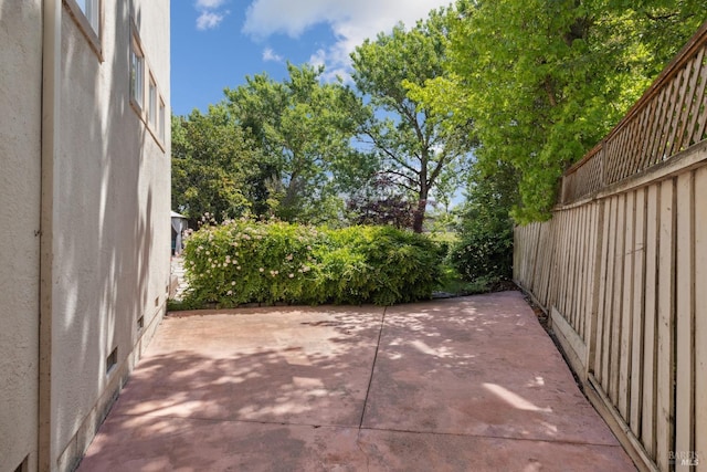 view of patio featuring fence