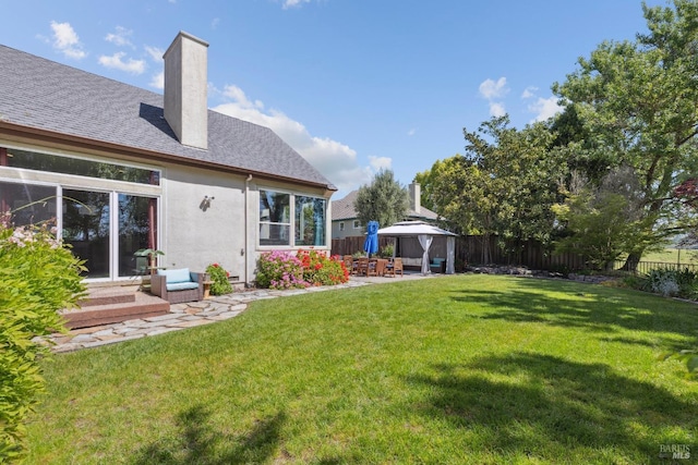 view of yard with a gazebo, a fenced backyard, a patio area, and entry steps