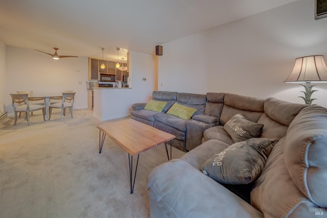 living room with baseboards and light carpet