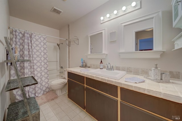 bathroom featuring visible vents, shower / bath combo with shower curtain, vanity, toilet, and tile patterned floors