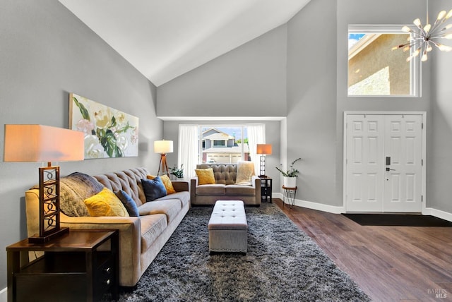 living area with high vaulted ceiling, healthy amount of natural light, wood finished floors, and baseboards