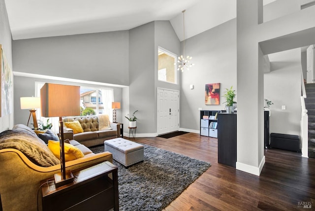 living room with baseboards, dark wood-style flooring, stairs, a chandelier, and high vaulted ceiling