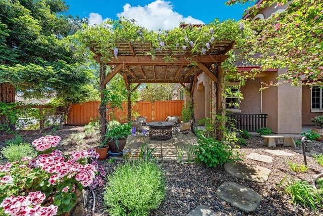view of yard with a fenced backyard, a patio, an outdoor fire pit, and a pergola