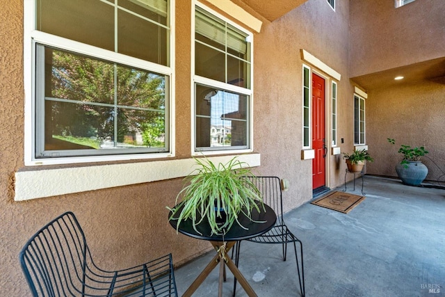 entrance to property with stucco siding