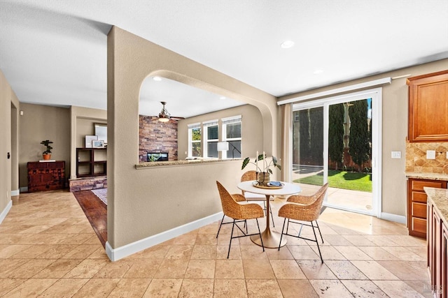 dining room with recessed lighting, ceiling fan, baseboards, and a fireplace