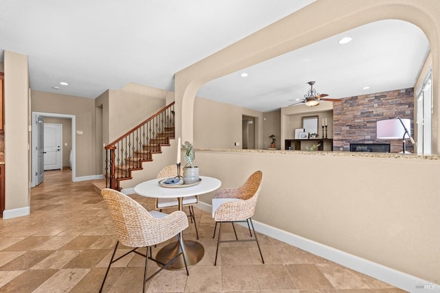 dining area with stairs, a fireplace, baseboards, ceiling fan, and recessed lighting