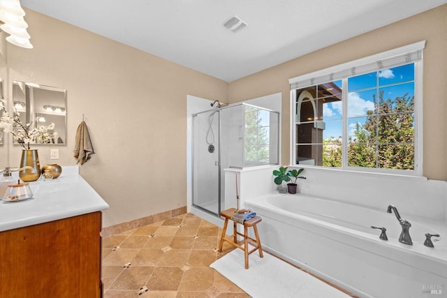 full bath featuring vanity, baseboards, a bath, and a shower stall