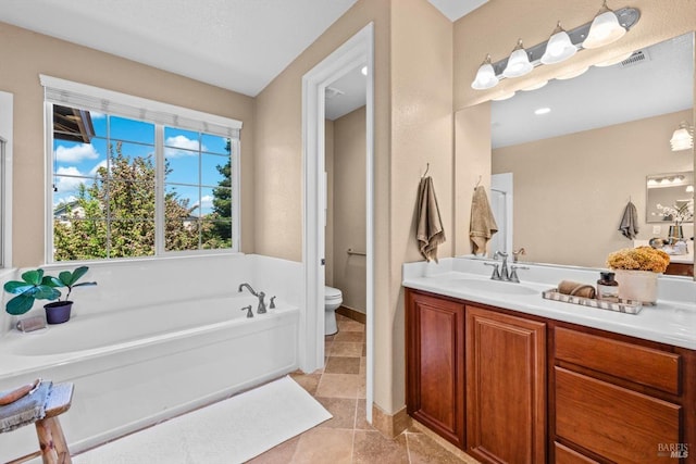 full bath featuring vanity, toilet, a bath, and visible vents