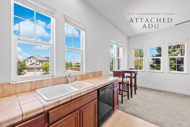 kitchen featuring a sink, tile countertops, brown cabinets, and dishwasher