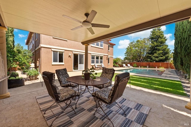 view of patio with a fenced in pool, a fenced backyard, ceiling fan, and outdoor dining area
