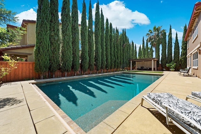 view of swimming pool with a patio, a fenced backyard, a pergola, and a fenced in pool