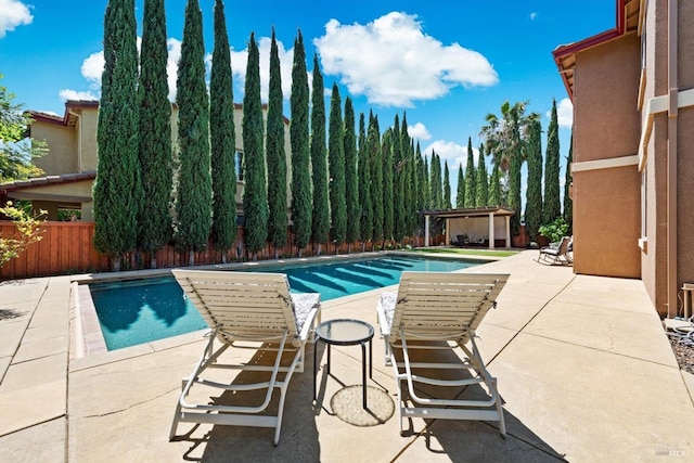 view of pool featuring fence, a fenced in pool, and a patio area
