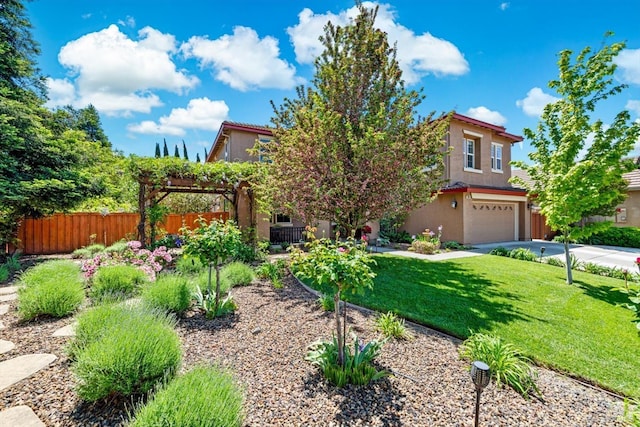 view of front of property featuring a garage, fence, a front yard, stucco siding, and driveway