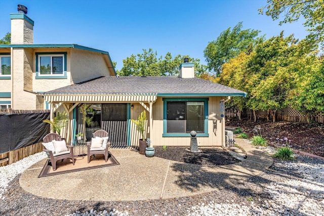 back of house featuring a patio, fence, and a chimney