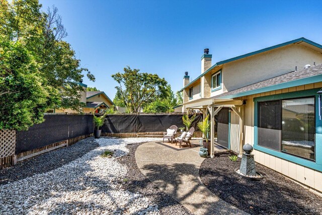 view of yard with a fenced backyard and a patio