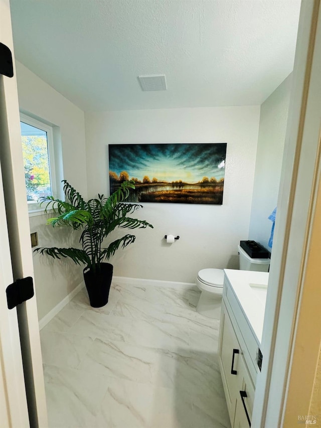 19 4th St, Richmond, CA 94801 - bathroom with vanity, marble finish flooring, toilet, baseboards, and a textured ceiling