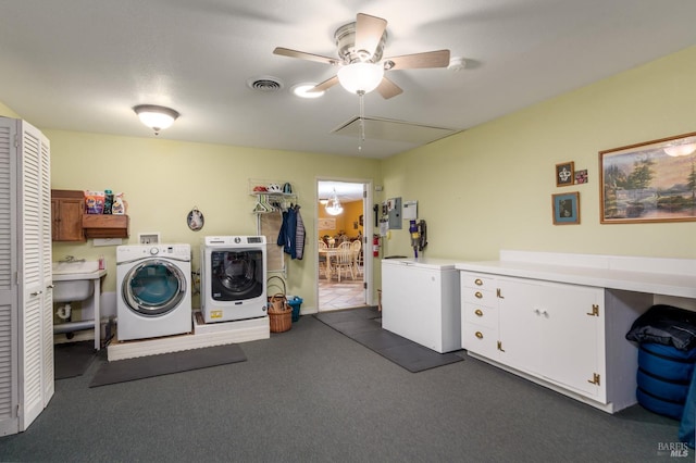 laundry area featuring ceiling fan, attic access, visible vents, washing machine and dryer, and cabinet space