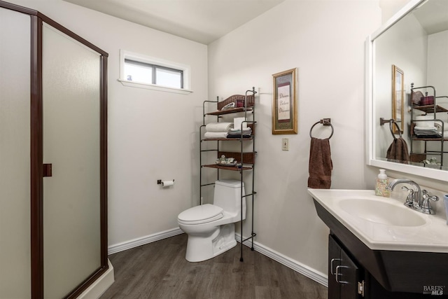 full bath featuring vanity, wood finished floors, toilet, baseboards, and a stall shower