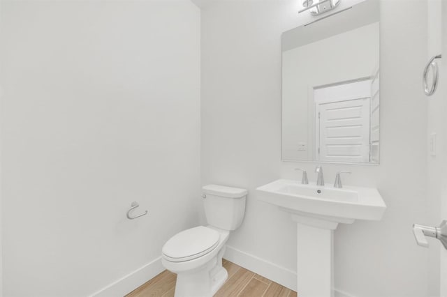 10592 Trill Way, Elk Grove, CA 95757 - half bath with a sink, baseboards, toilet, and wood finished floors
