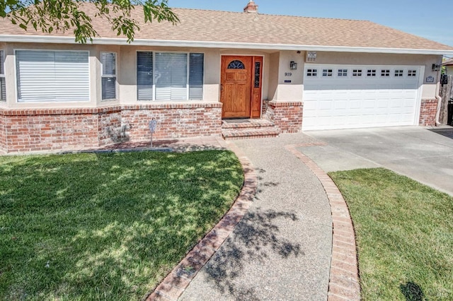 single story home with stucco siding, driveway, and brick siding