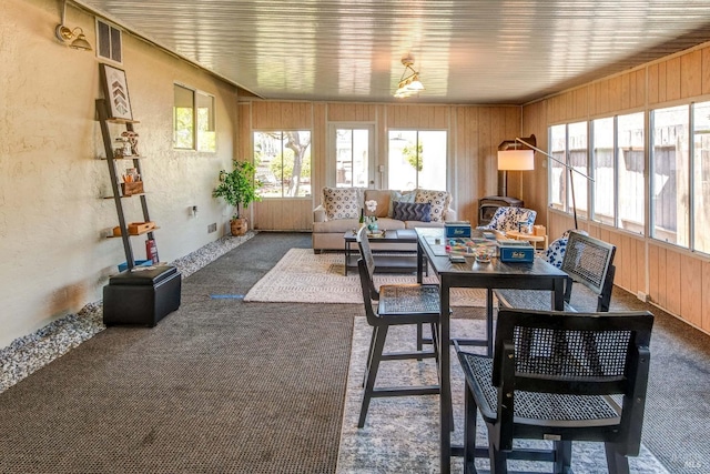 sunroom featuring visible vents and outdoor lounge area