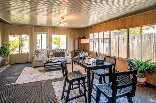sunroom with outdoor lounge area and outdoor dining space