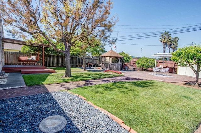view of yard featuring a gazebo, a fenced backyard, and a patio
