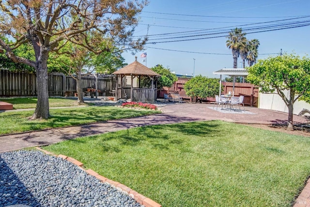 view of yard featuring a fenced backyard, a patio, and a gazebo