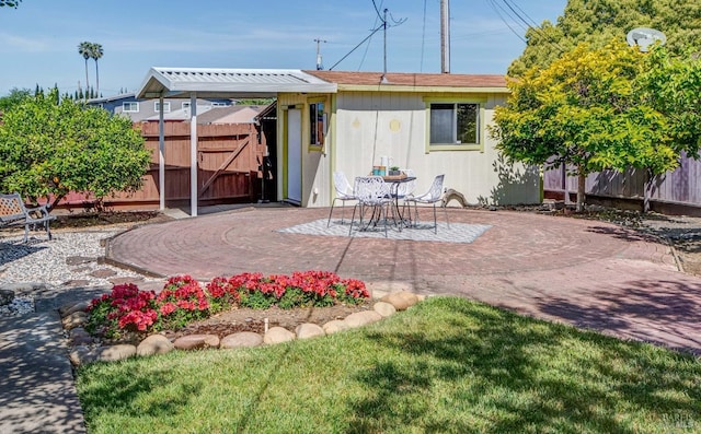 back of property with a patio area and fence