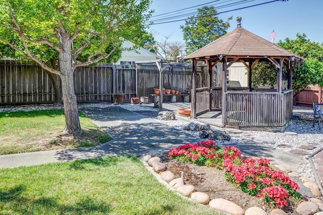 view of yard featuring a fenced backyard and a gazebo