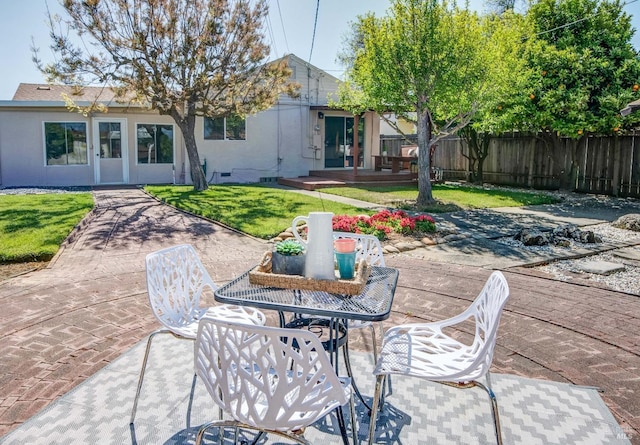 exterior space with outdoor dining area, fence private yard, and a deck
