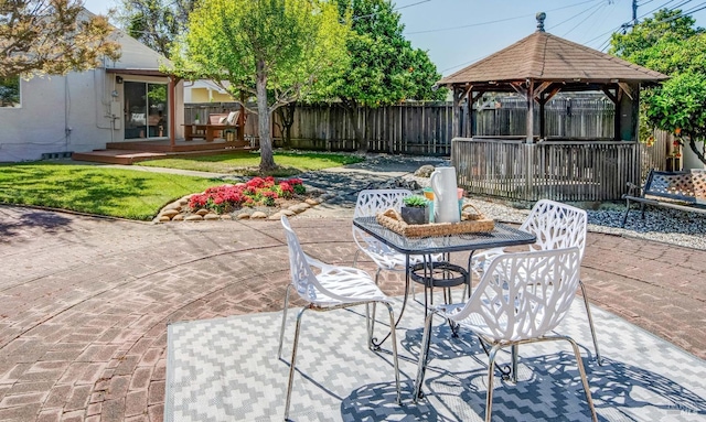 view of patio with a deck, a gazebo, and a fenced backyard