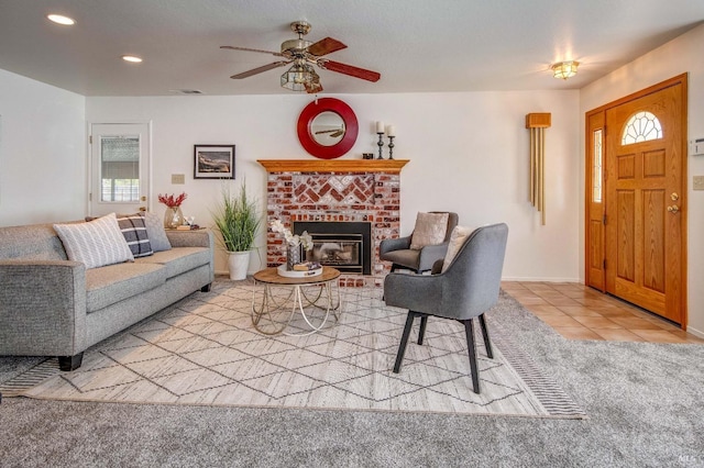 tiled living room featuring visible vents, a brick fireplace, baseboards, recessed lighting, and a ceiling fan
