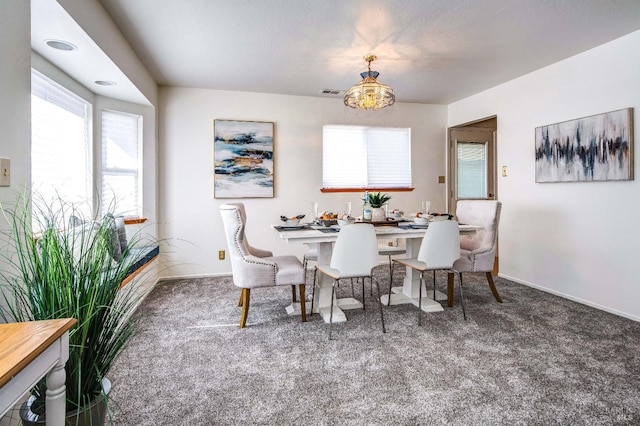 dining space with carpet floors, baseboards, and visible vents