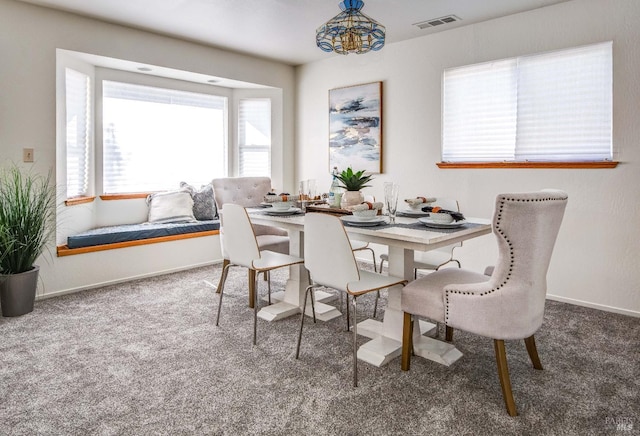 dining area with carpet floors, baseboards, and visible vents