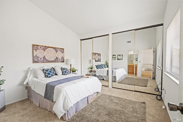 bedroom with visible vents, connected bathroom, carpet, and high vaulted ceiling