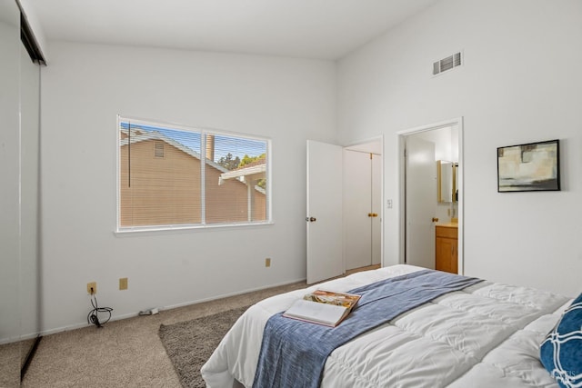 carpeted bedroom featuring visible vents, baseboards, ensuite bathroom, and high vaulted ceiling