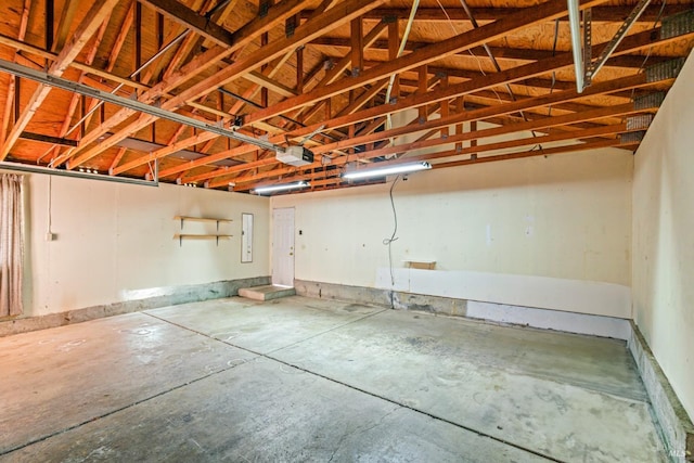 garage featuring a garage door opener and electric panel