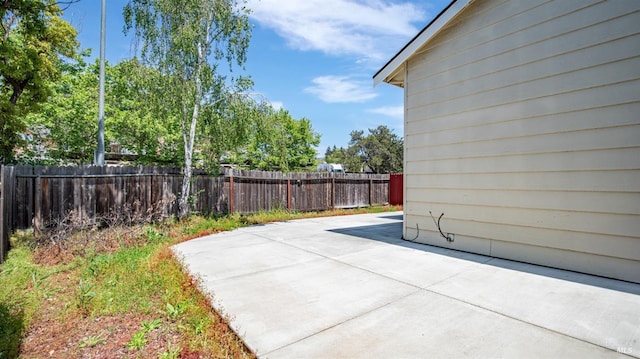 view of patio featuring fence