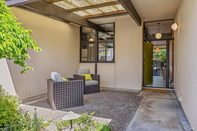 view of exterior entry with a patio