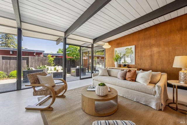 sunroom featuring beamed ceiling, an outdoor living space, and plenty of natural light