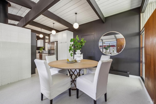 dining room with a baseboard heating unit and beamed ceiling